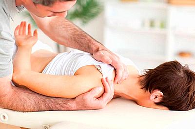Gorgeous brunette woman getting a shoulder-massage-stock-photo