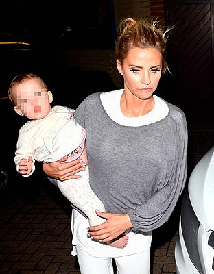 Katie Price, husband Kieran Hayler, and their daughter Bunny leave the New Victoria Theatre after Price's opening night performance in 'Sleeping Beaut...-stock-photo