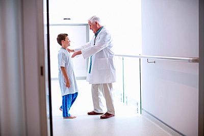 Doctor talking to boy patient-stock-photo