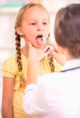 Young female pediatrician examining throat of her little cute patient.-stock-photo